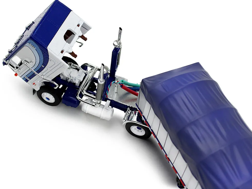 Peterbilt 352 COE 110" Sleeper and 53’ Wilson Roadbrute Flatbed Trailer with Covered Wagon White with Blue Stripes 1/64 Diecast Model by DCP/First Gear