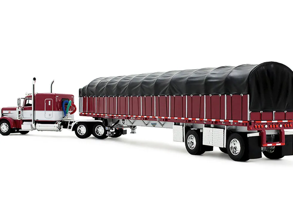 Peterbilt 389 with 63" Flat Top Sleeper and 53’ Wilson Roadbrute Flatbed Trailer with Covered Wagon Maroon with White Stripes 1/64 Diecast Model by DCP/First Gear