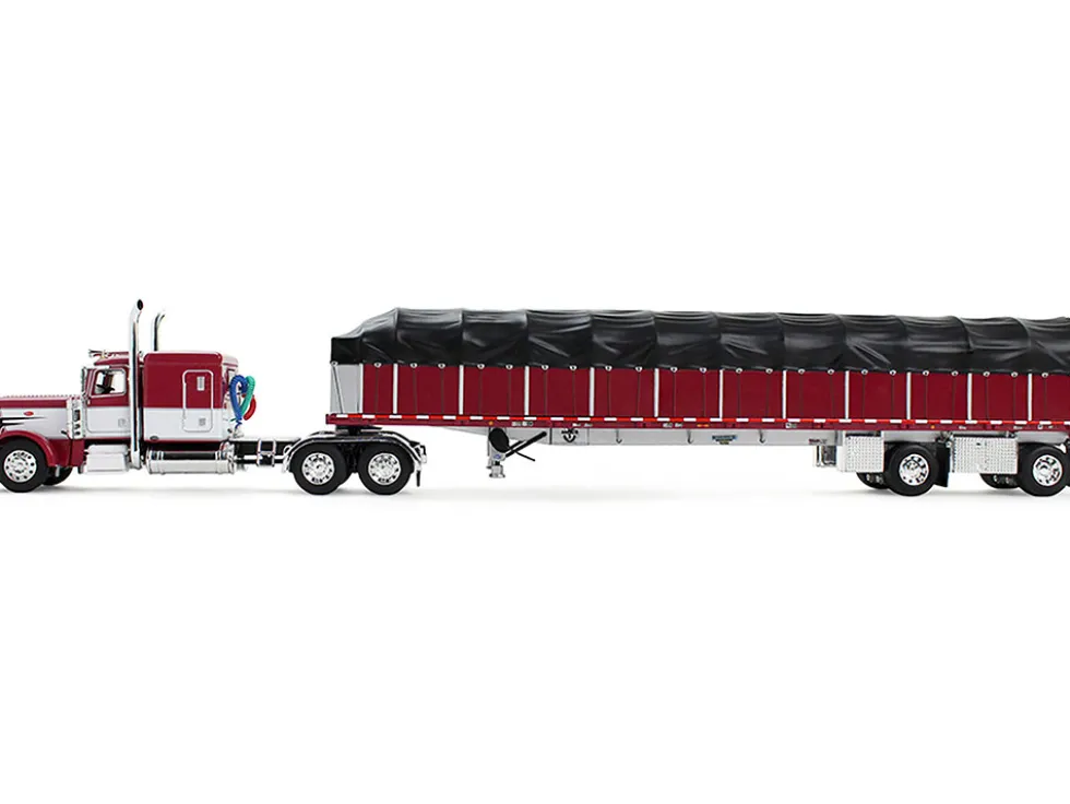 Peterbilt 389 with 63" Flat Top Sleeper and 53’ Wilson Roadbrute Flatbed Trailer with Covered Wagon Maroon with White Stripes 1/64 Diecast Model by DCP/First Gear